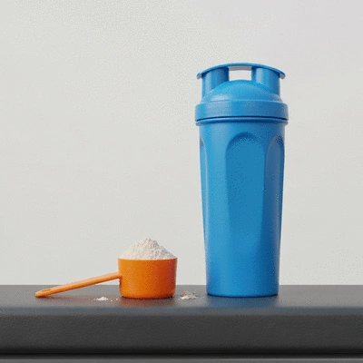Protein powder and shaker bottle on a gym bench